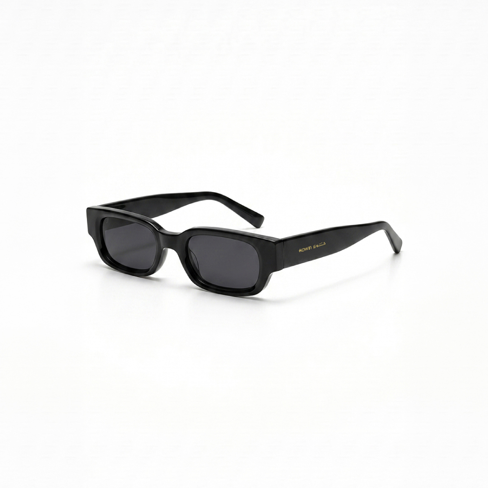 KOWN AURA — chunky black rectangular sunglasses with dark lenses, three-quarter view