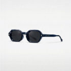 KOWN ECLIPSE — navy octagonal sunglasses with metal rivets and dark lenses, three-quarter view