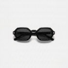 KOWN ONYX — black octagonal sunglasses with dark lenses, three-quarter view
